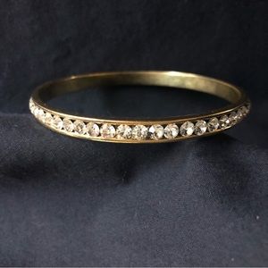 Solid gold tone thin bracelet with white crystal stones